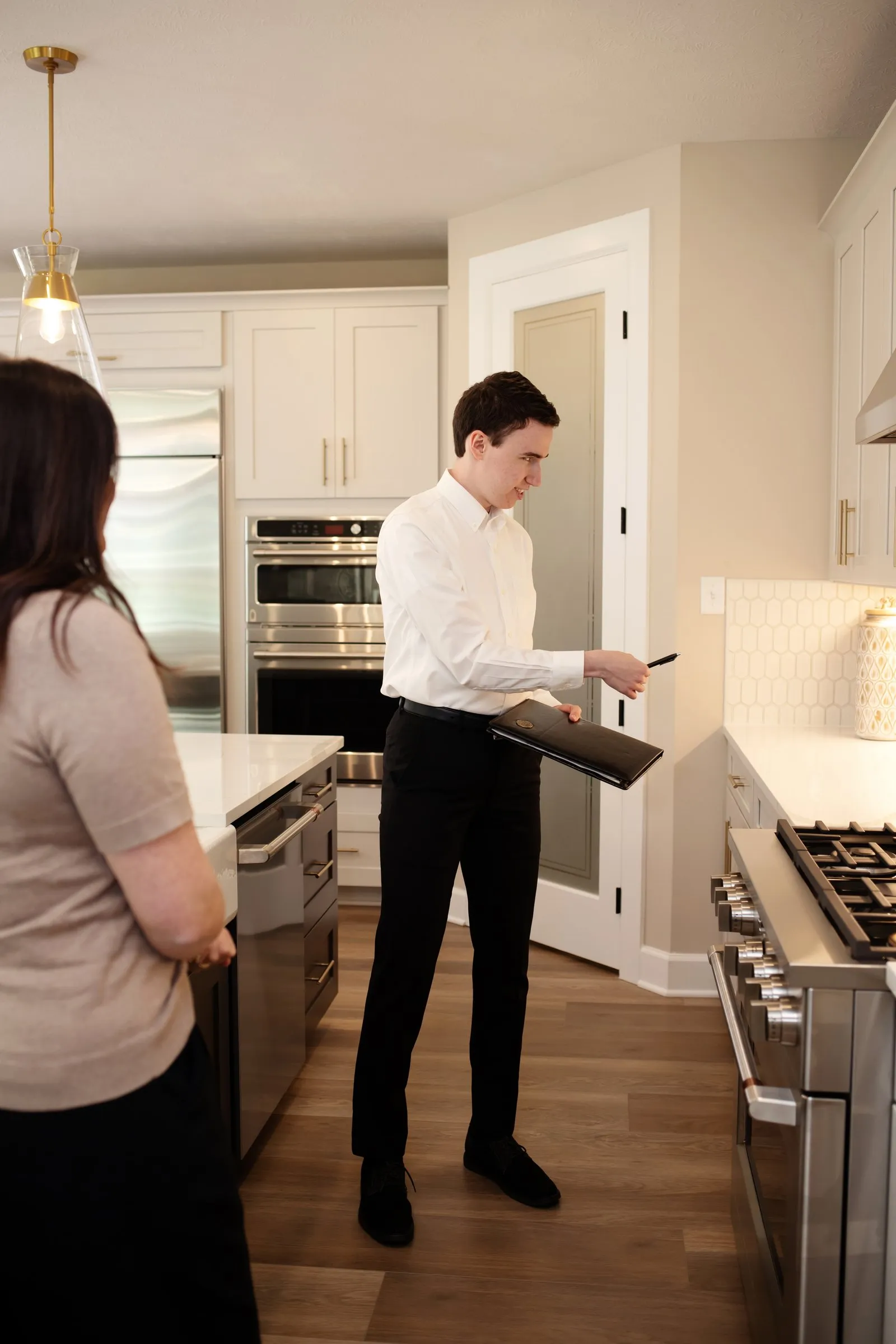 Matt Stehnach walking clients through a kitchen