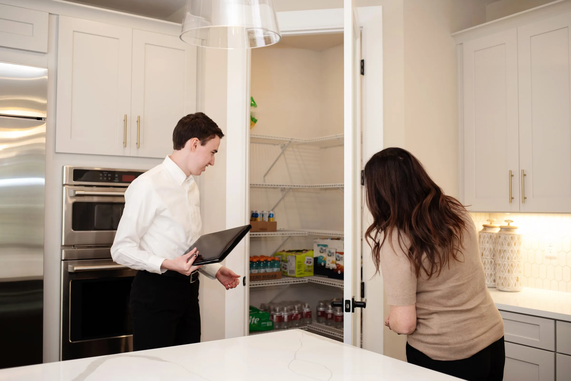 Jill and Matt Stehnach with buyers in a kitchen