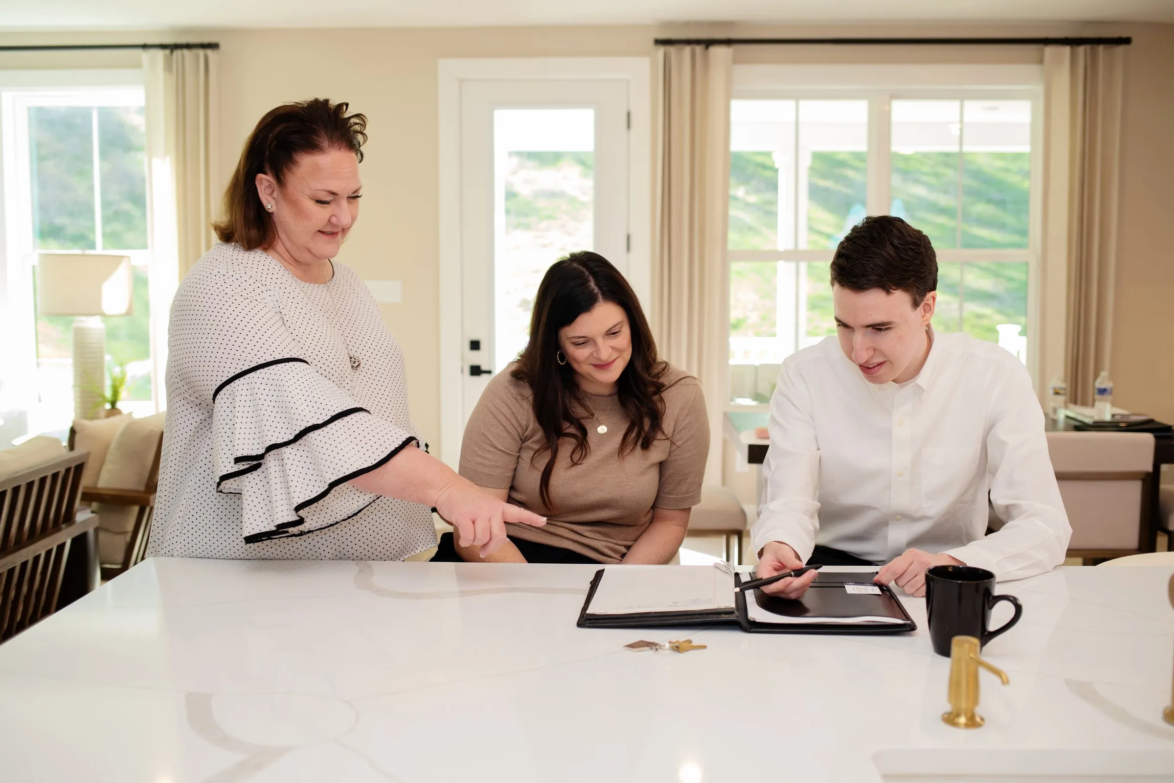Jill and Matt Stehnach reviewing paperwork with clients